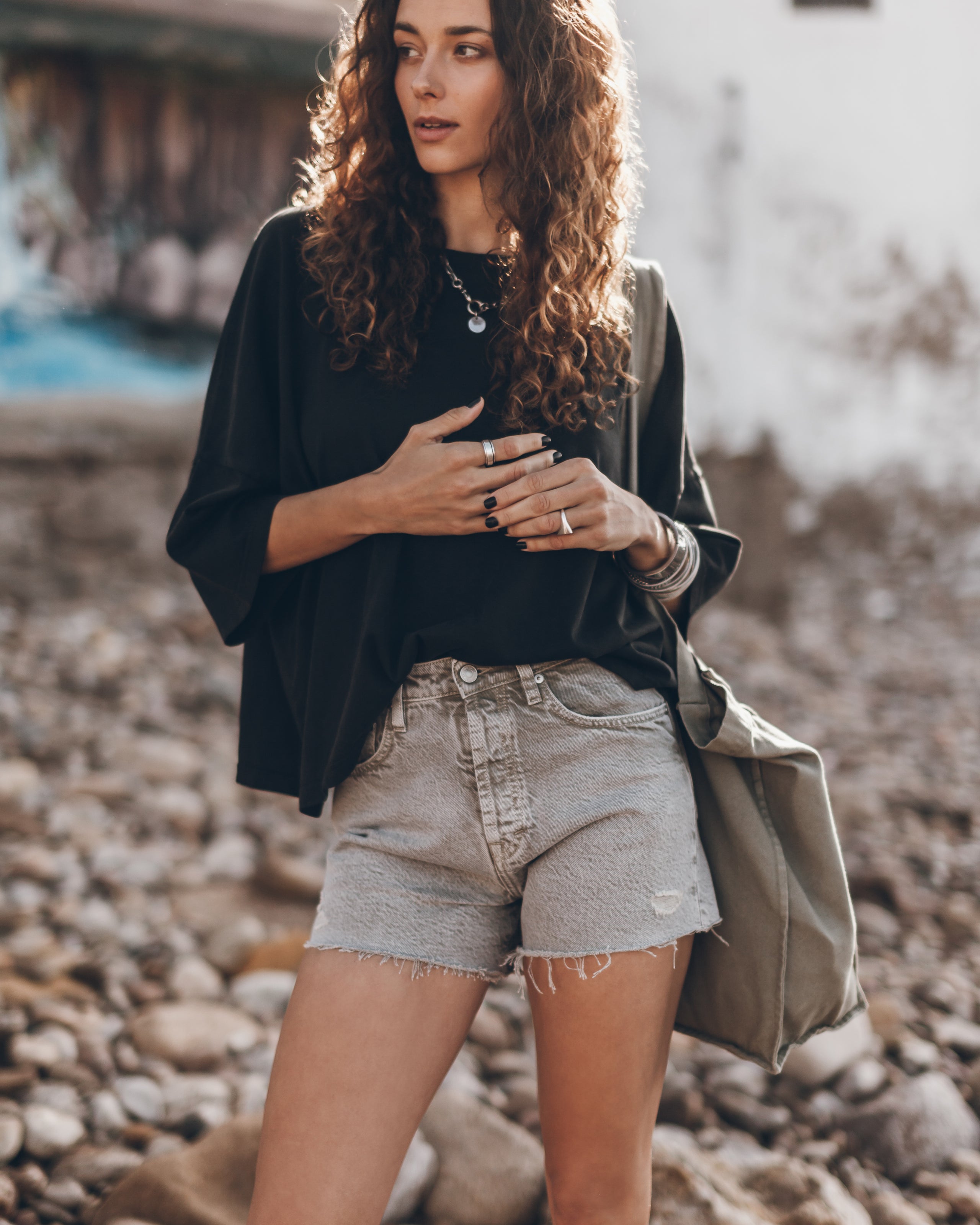 Khaki Faded Denim Shorts Dark Loose Cotton Shirt Black Laced Leather Boots Khaki Large Canvas Bag...