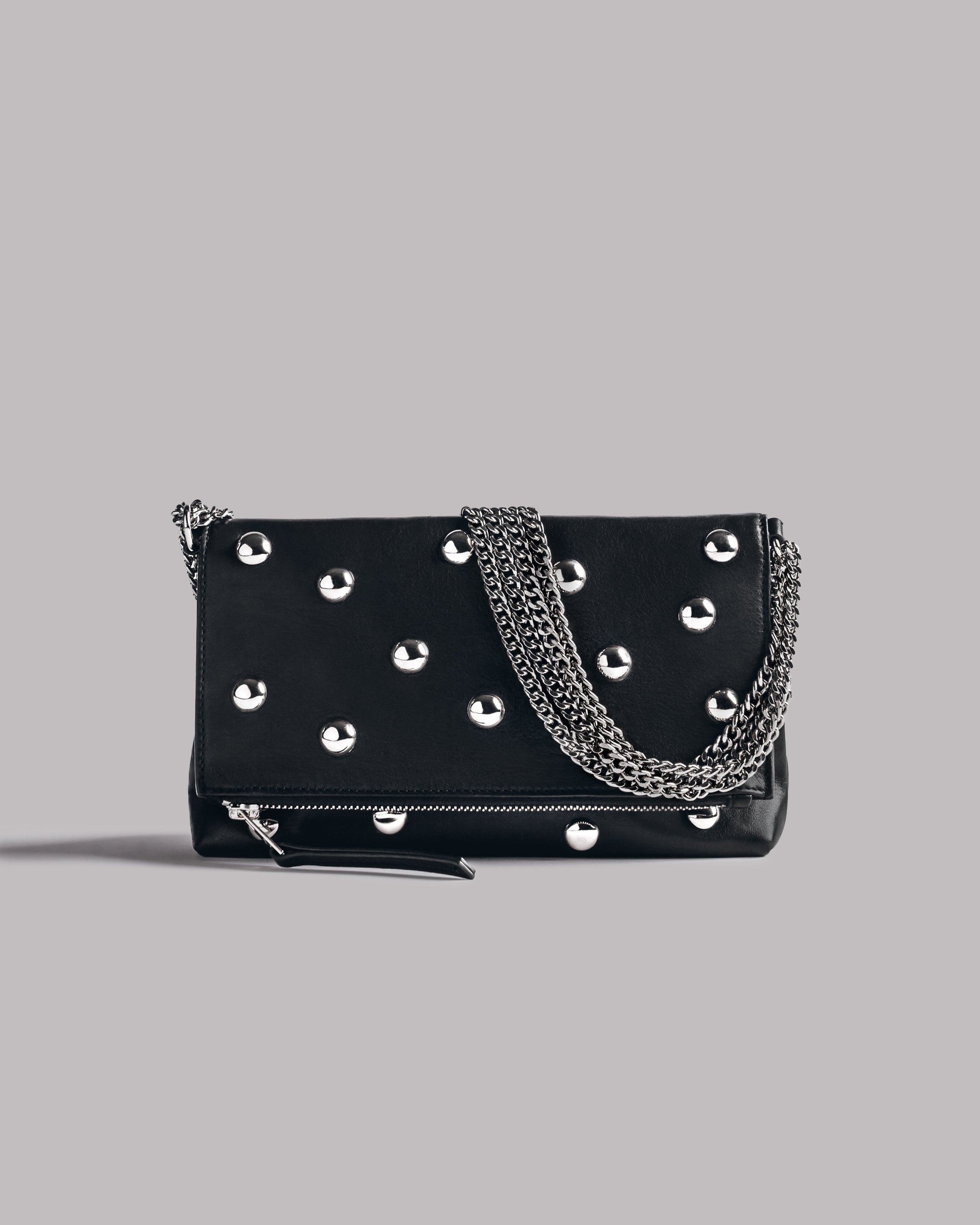 Black studded bag with chain detail on a gray background