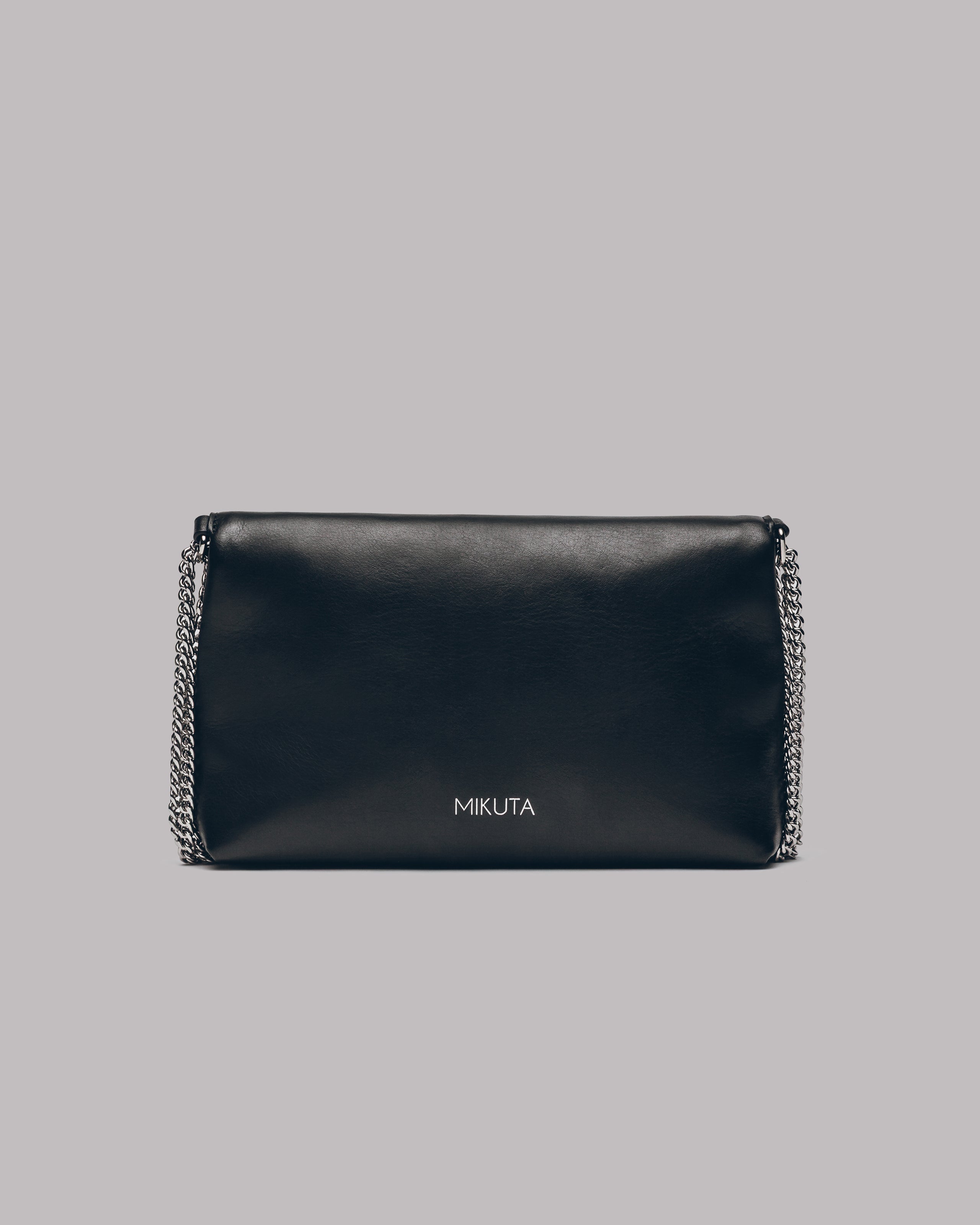 Black clutch bag with chain detail on a gray background