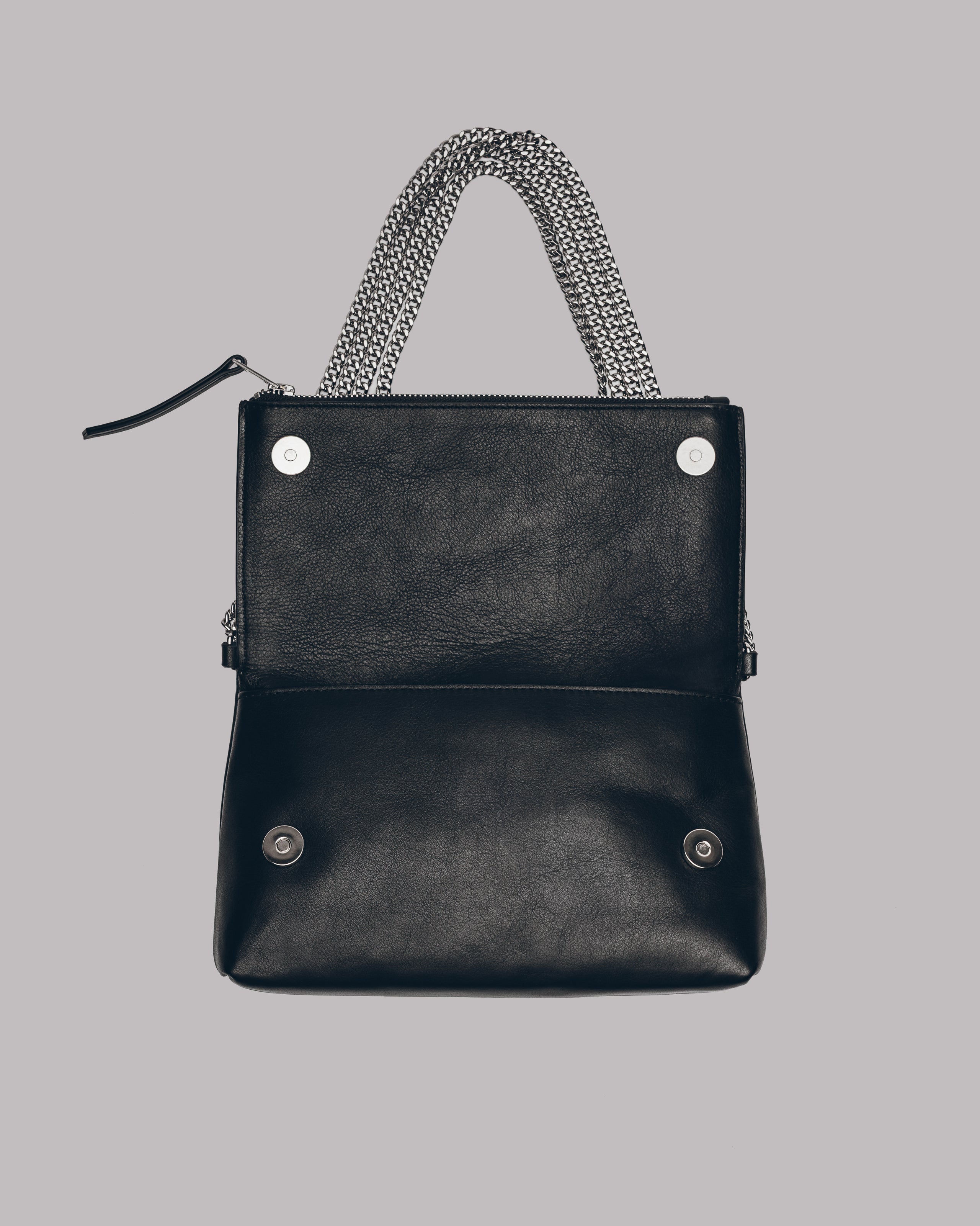 Black handbag with chain handle on a gray background