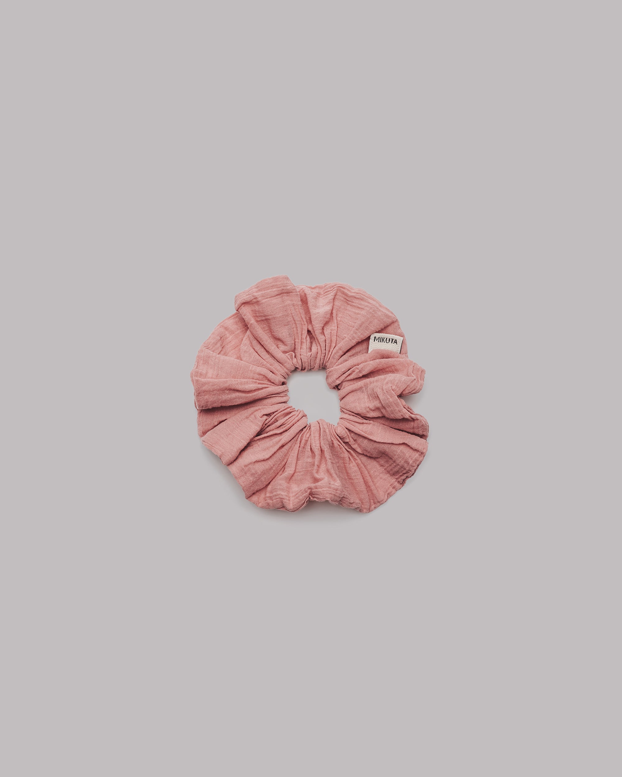 Pink scrunchie on a gray background