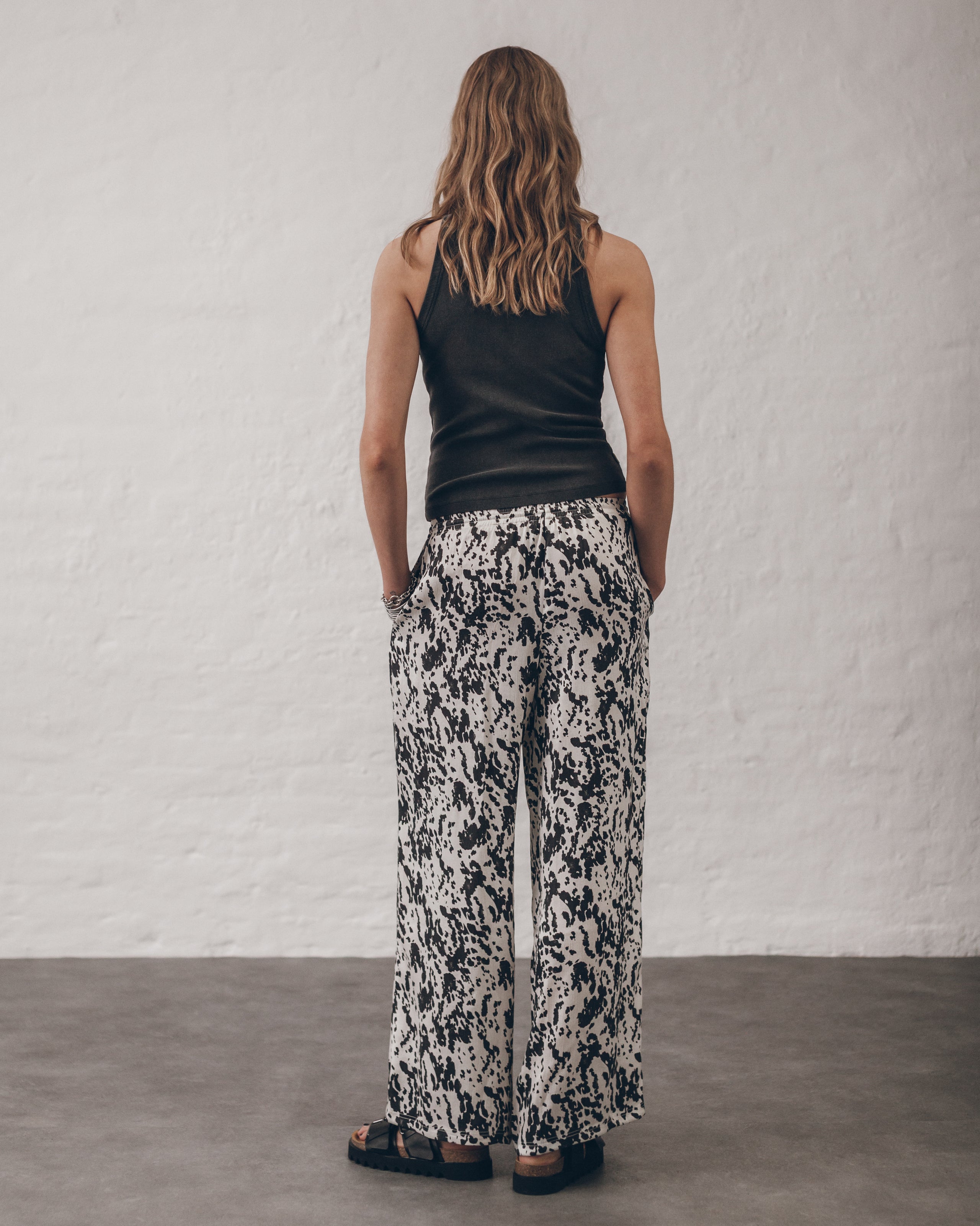 The Dalmatian Flowy Pants The Dark Faded Standard Tank Top The Black Leather Buckle Sandals The B...