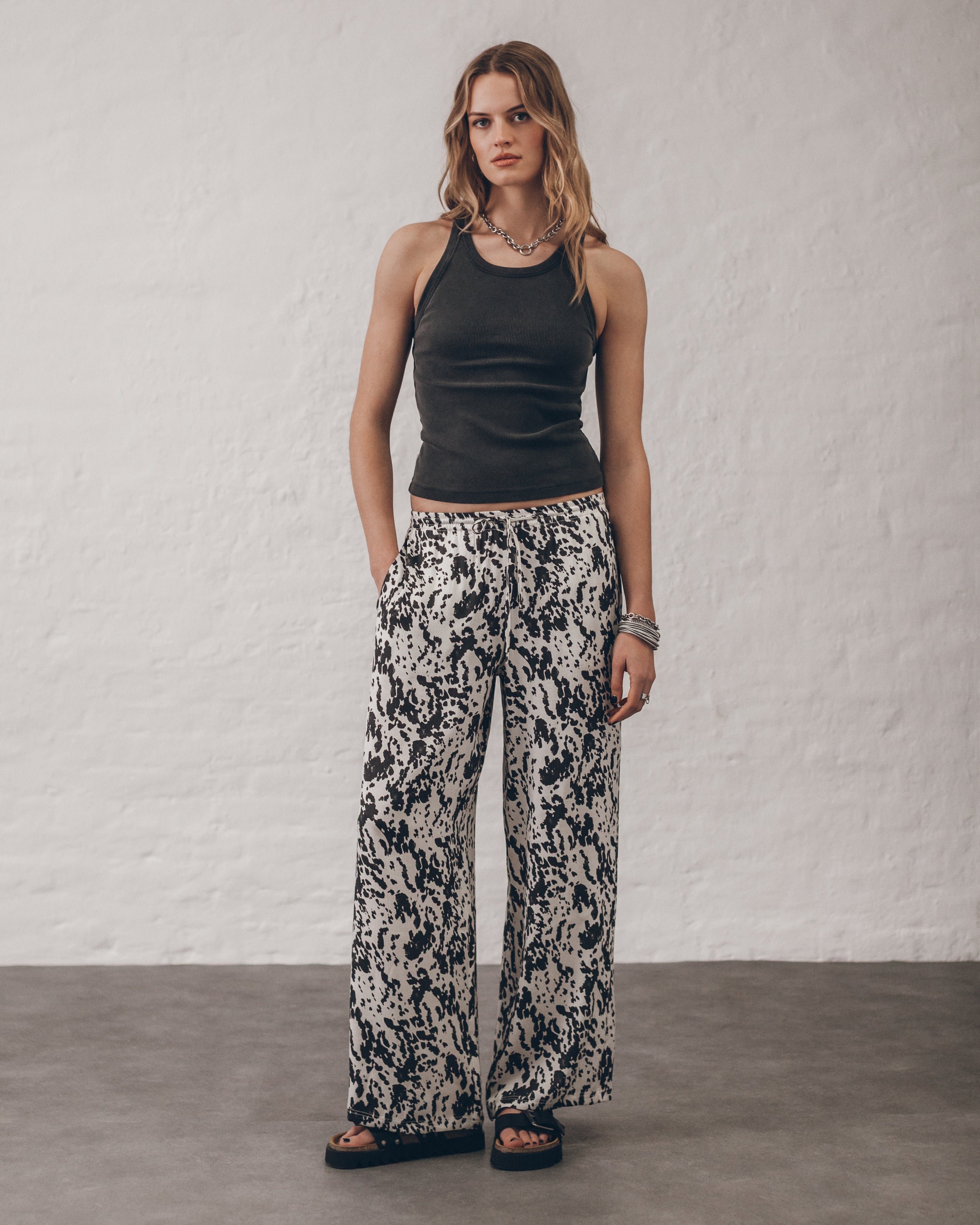 The Dalmatian Flowy Pants The Dark Faded Standard Tank Top The Black Leather Buckle Sandals The C...