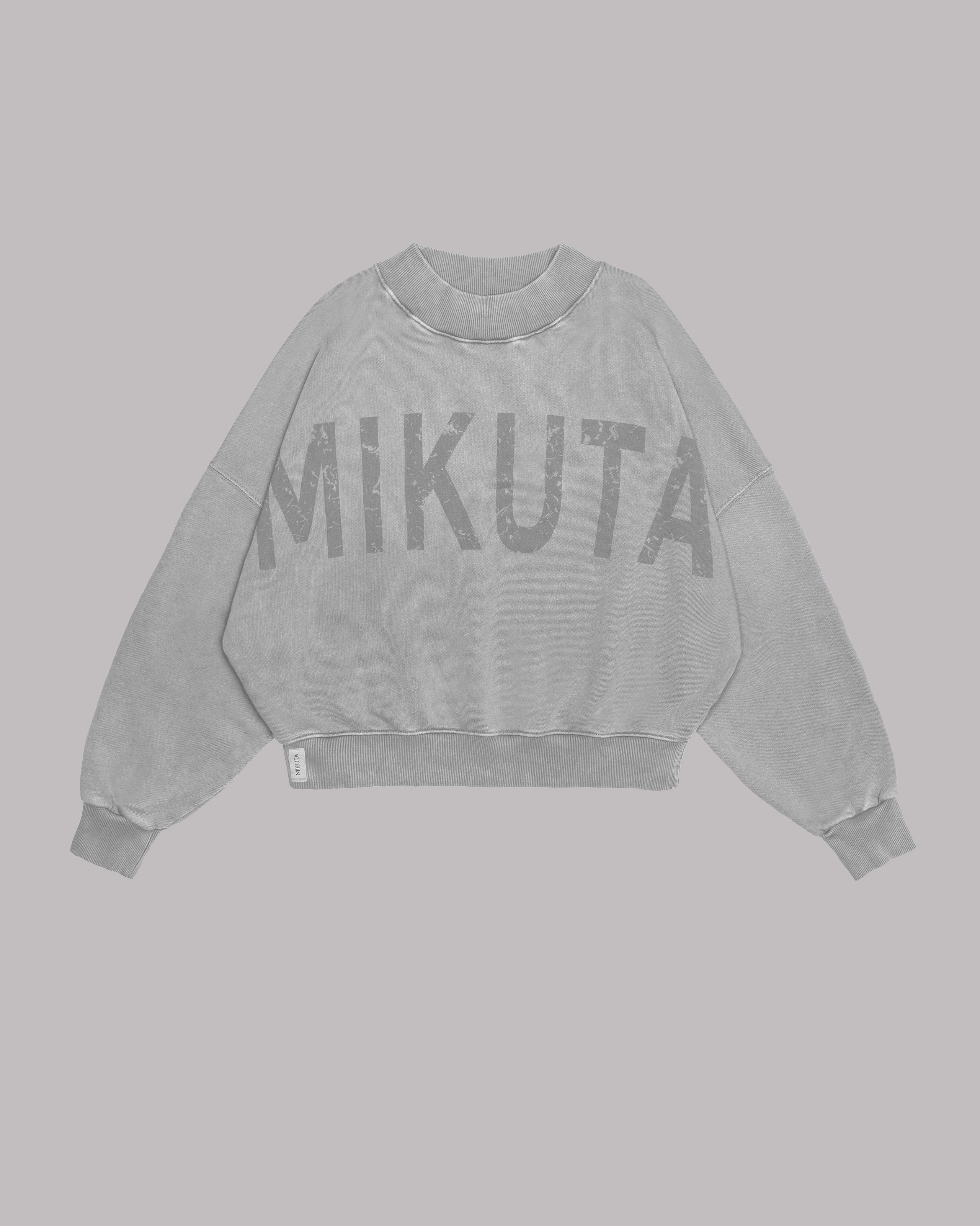 Light MIKUTA sweater product shot - cozy branded knitwear