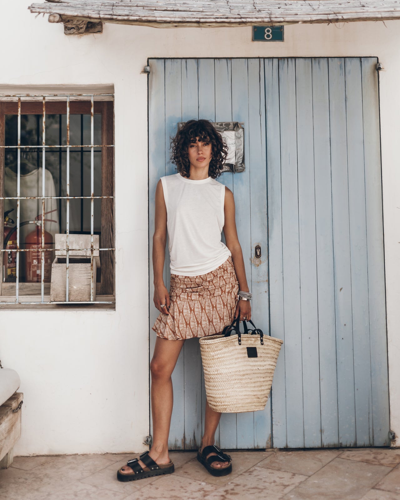 The Printed Draped Skort The White Draped Tank Top The Black Leather Buckle Sandals The Large Ces...