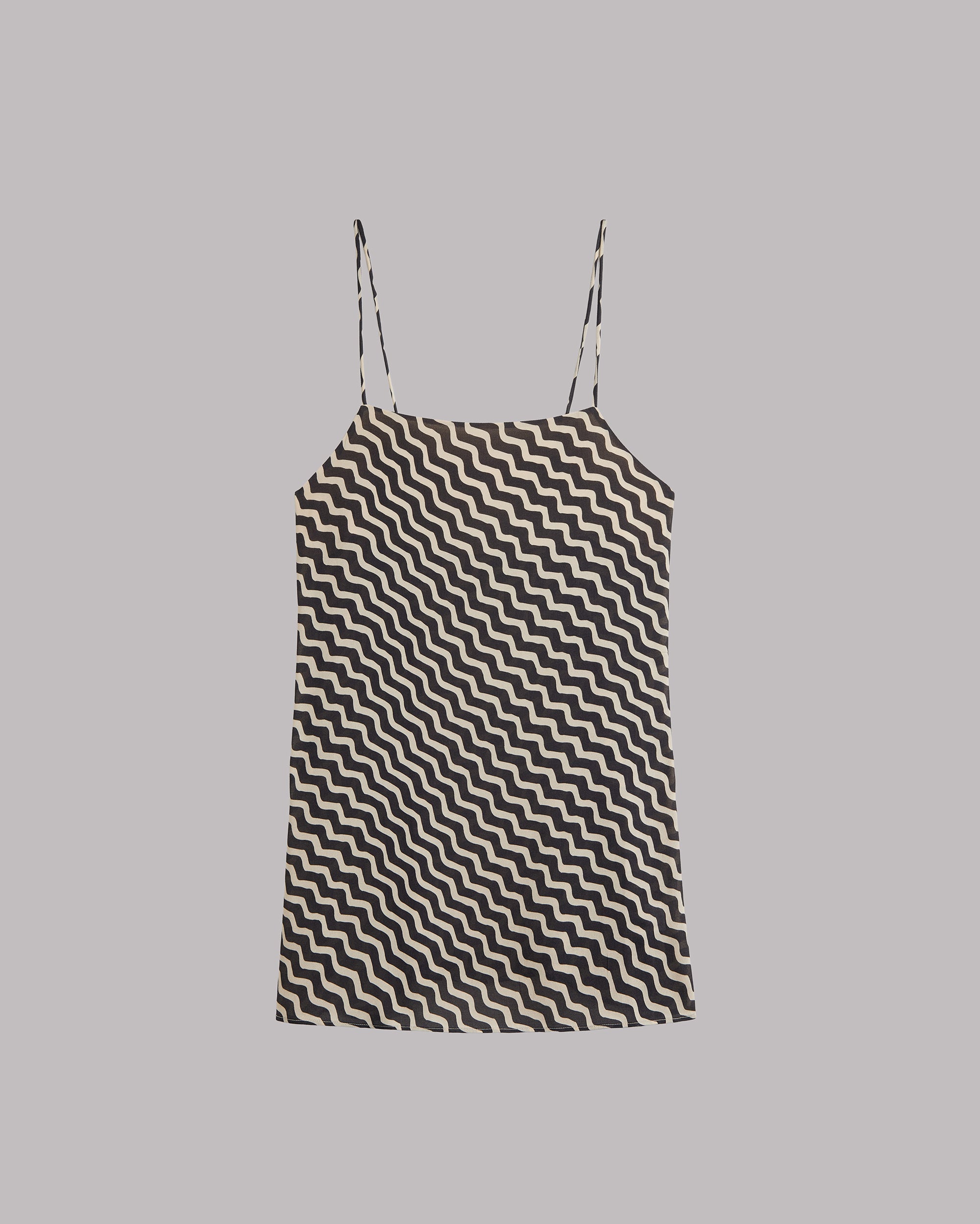 Black and white zigzag patterned dress on a gray background