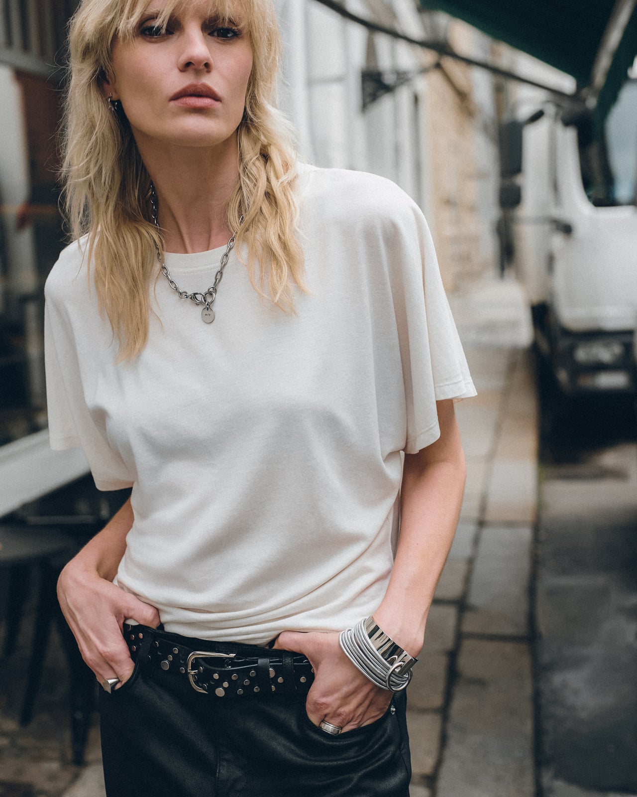 The White Bat Shirt The Straight Leather Pants The Black Studded Leather Sandals The Studded Belt...