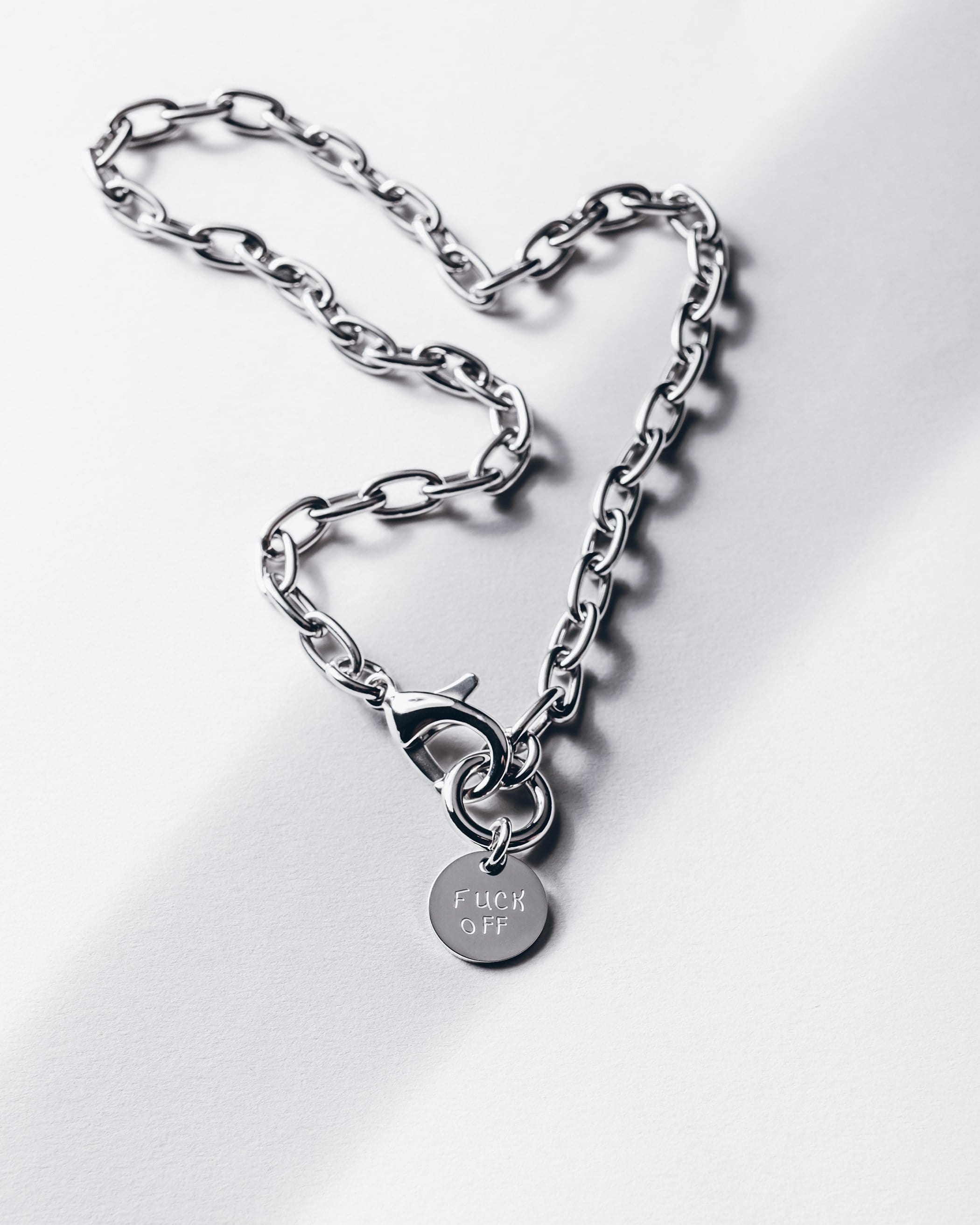 Silver F* Off necklace product shot - statement jewelry piece