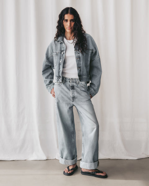 Blue Cropped Denim Jacket Blue Baggy Jeans White Standard Tank Top Black Studded Leather Sandals ...