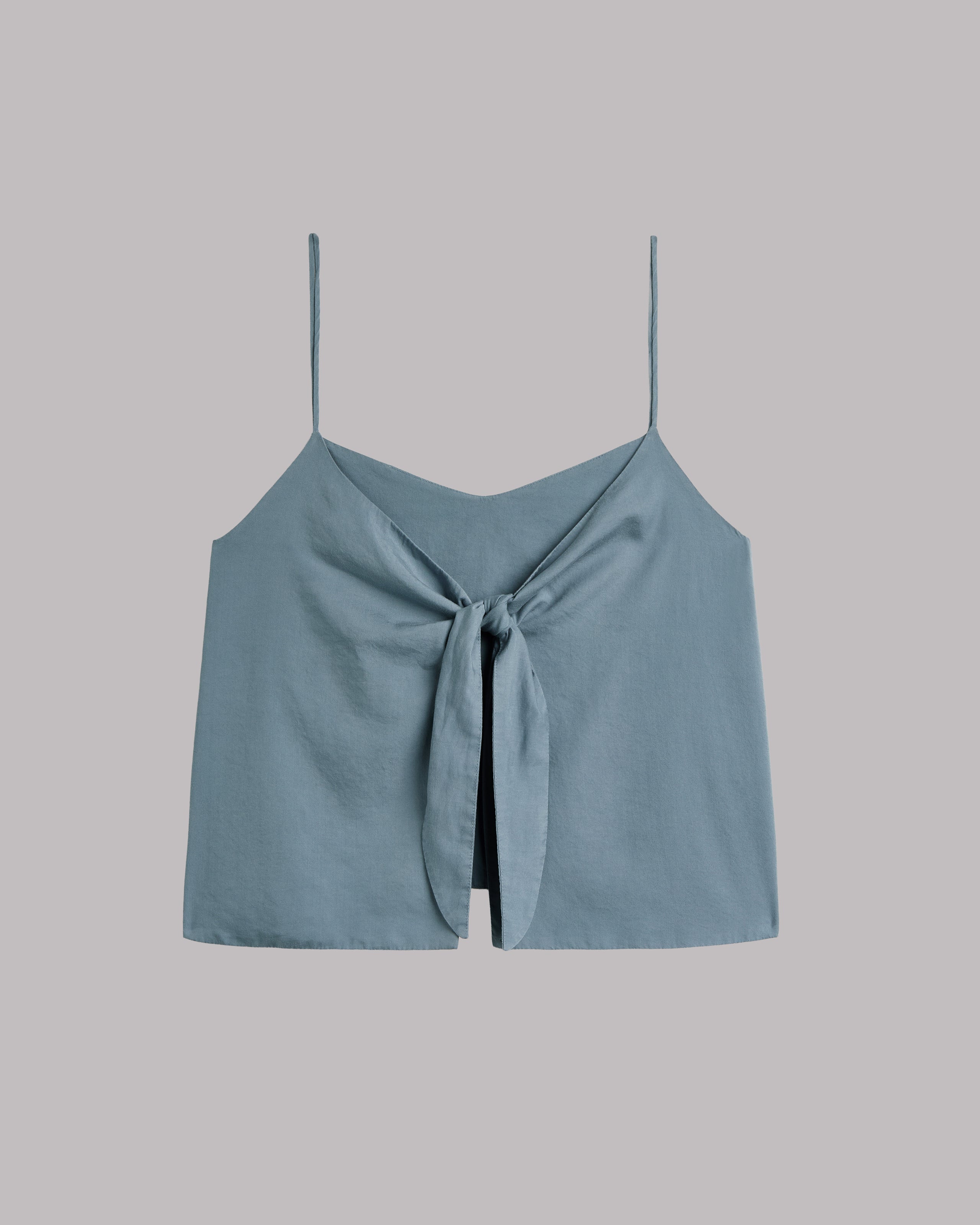 Light blue sleeveless top with a knot detail on a gray background