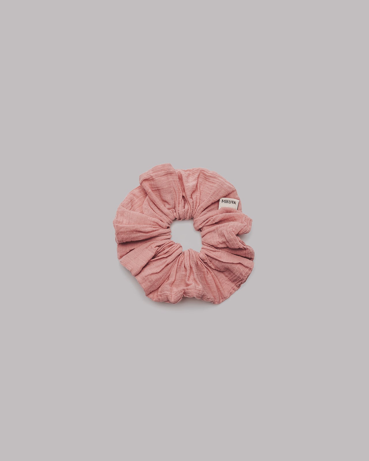 Pink scrunchie on a gray background