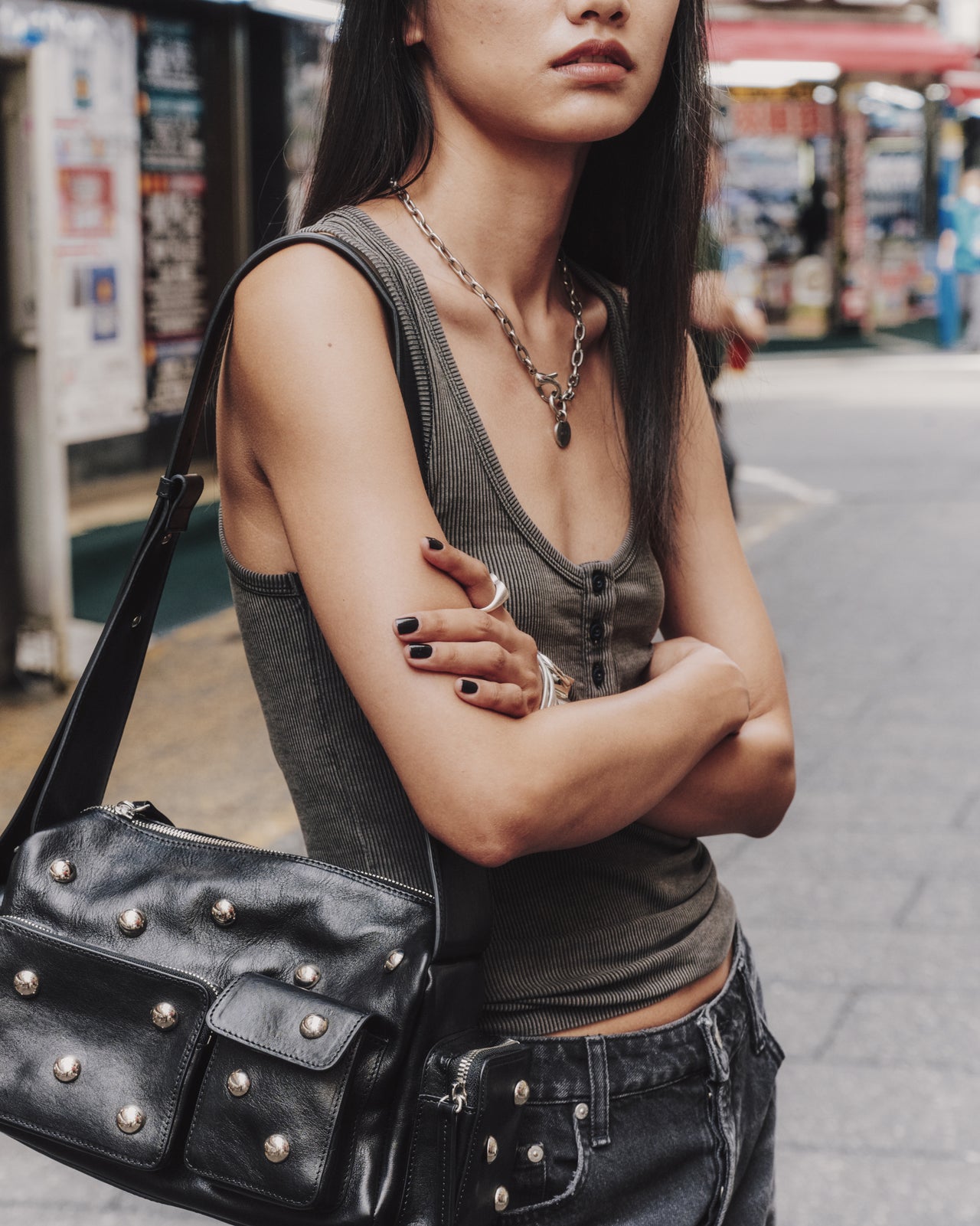 Woman with a studded black leather bag on a street