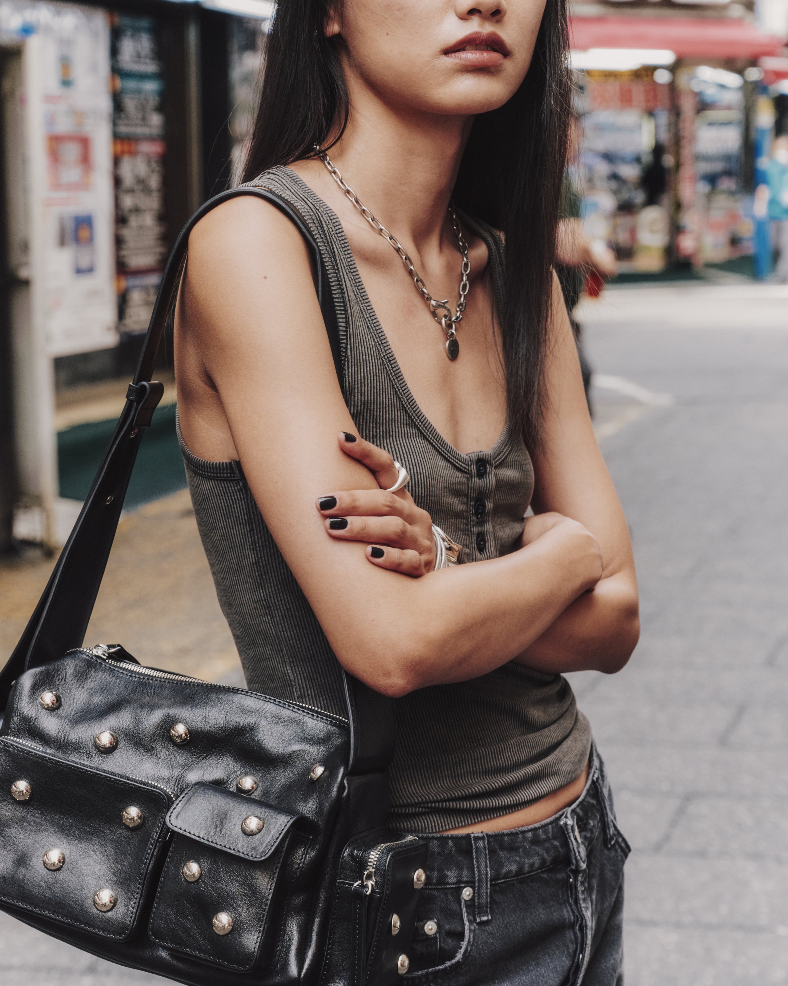 Woman with a studded black leather bag on a street
