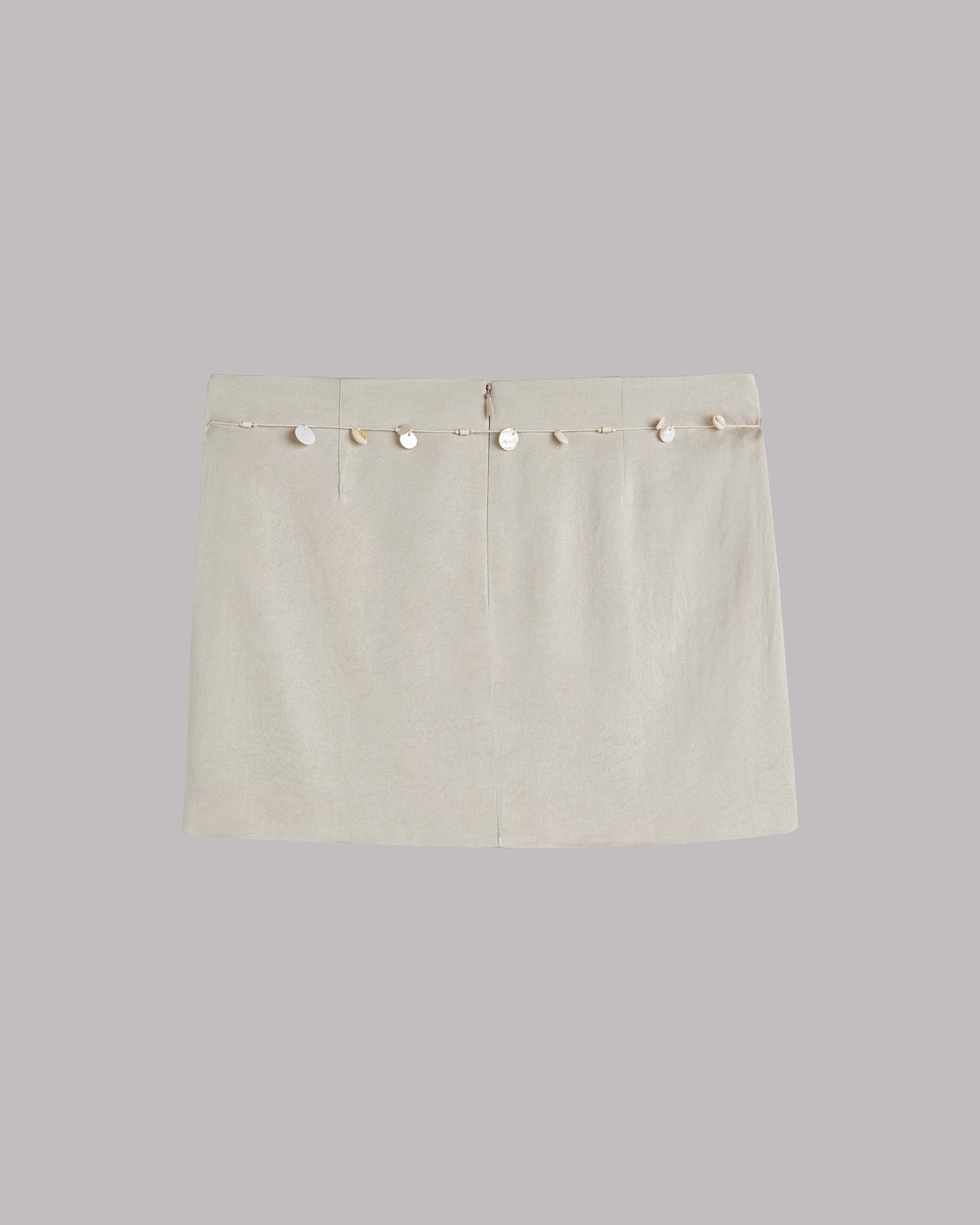 Beige skirt with shell details on a light gray background