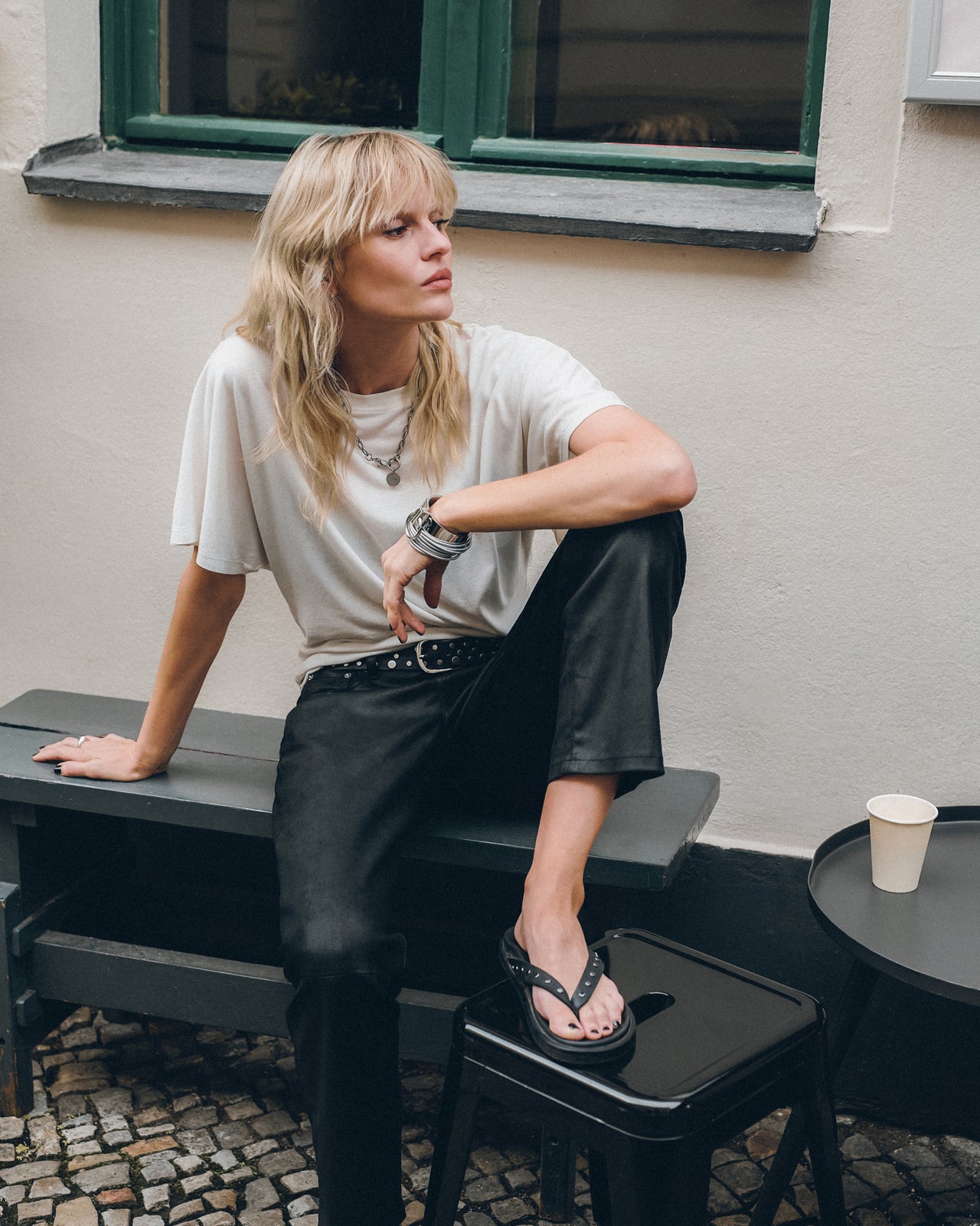 The White Bat Shirt The Straight Leather Pants The Black Studded Leather Sandals The Studded Belt...