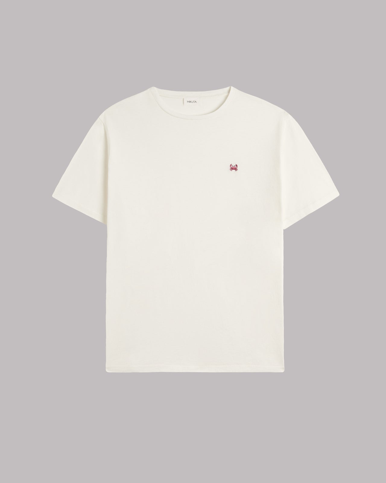 White t-shirt with a small crab icon on a gray background