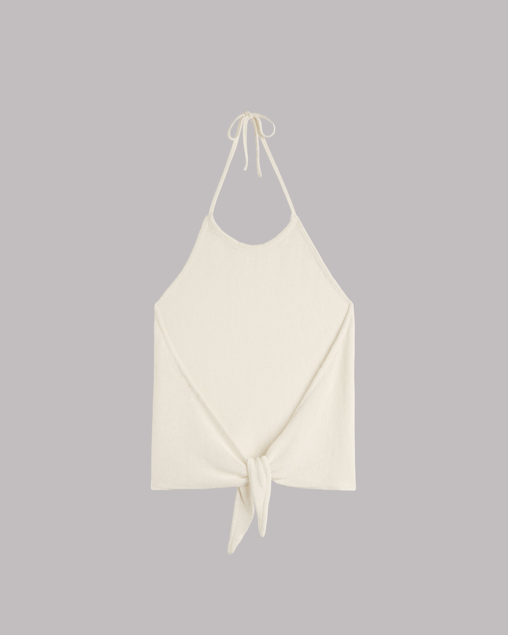 White halter neck top with tie detail on a gray background