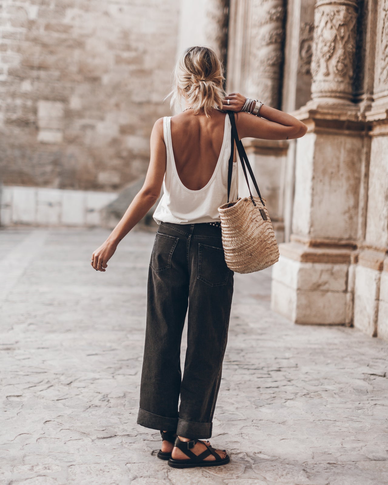 The White Low Back Base Tank Top The Black Baggy Jeans The Studded Belt The Large Cesta Bag The B...