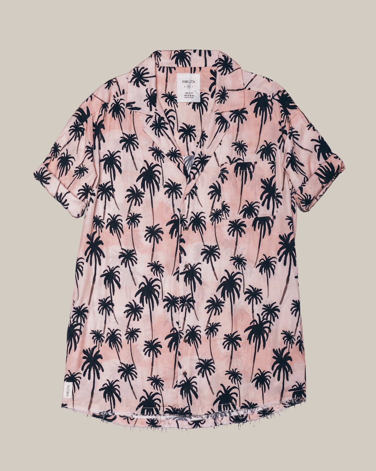 Pink short-sleeve button-up shirt with black palm tree print and camp collar.