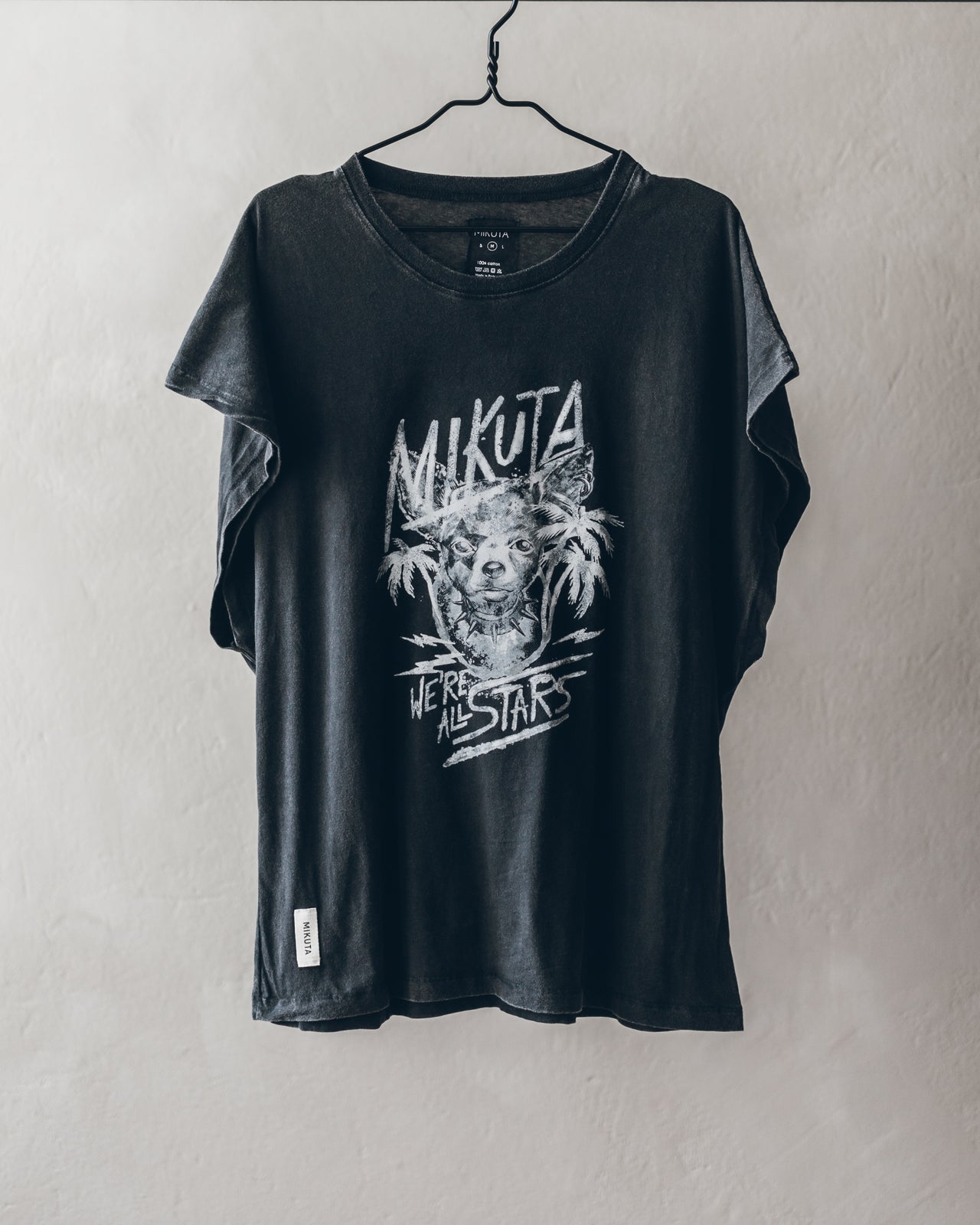 Black short-sleeve T-shirt with white graphic palm tree and text design, crew neckline.